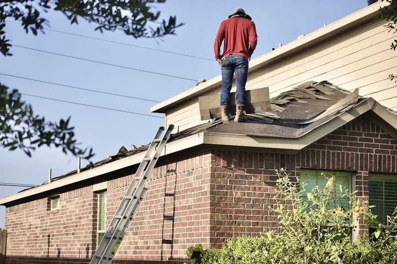 Professional roofer working on a residential roof in Pine Valley Farms
